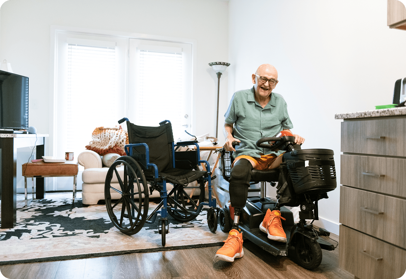 Man on mobility scooter in living room.