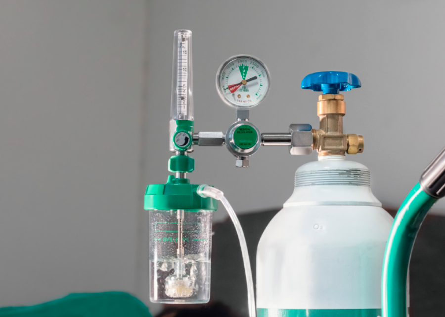 Medical oxygen tank with regulator and flow meter.