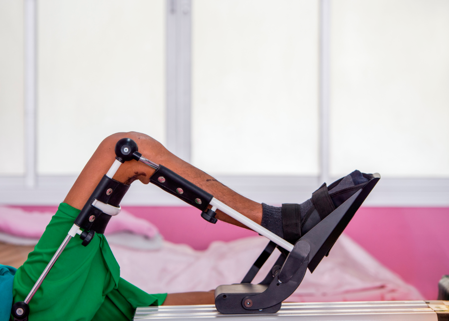 Child using a tablet with a robotic arm attachment.